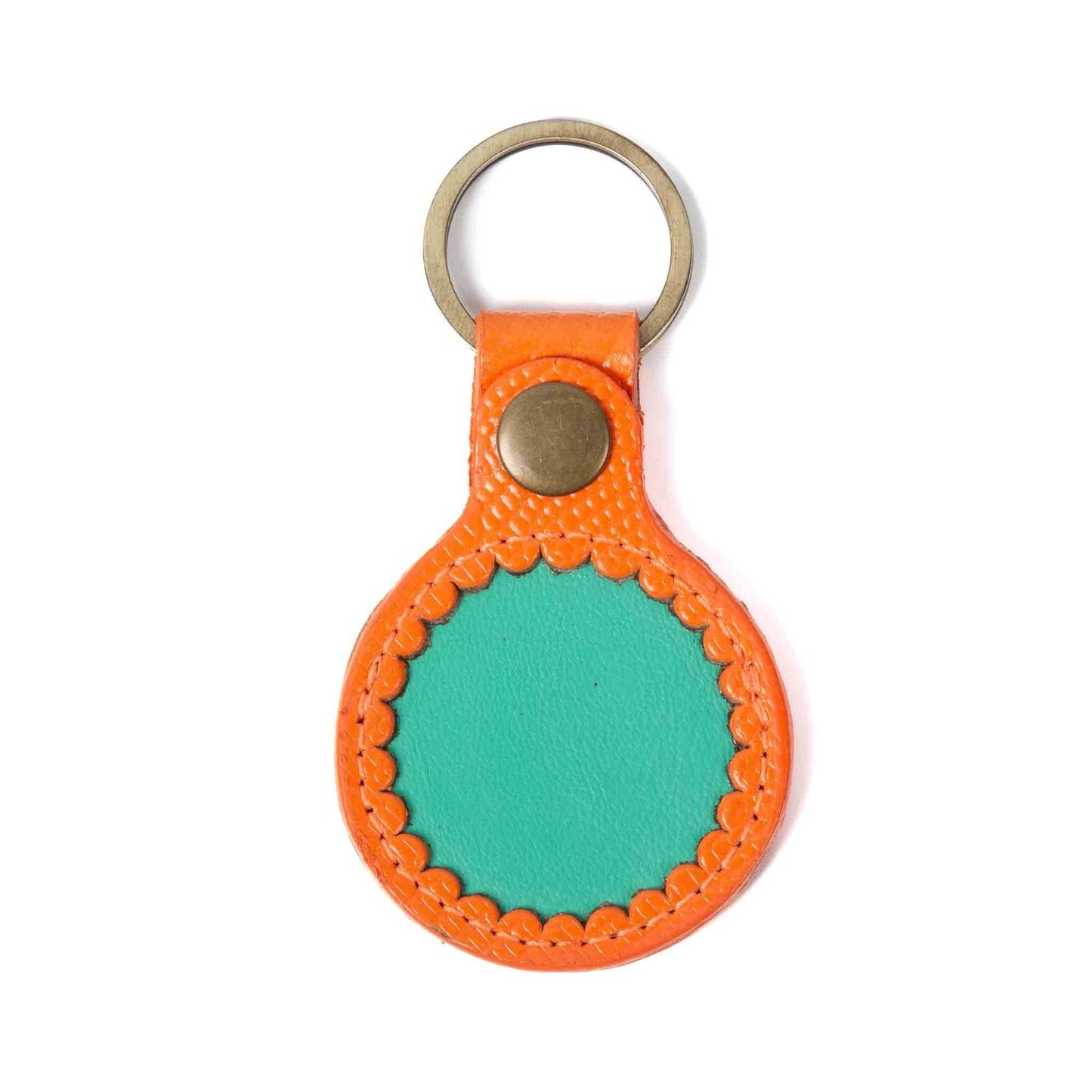 Anhänger für AirTag, oben mit Ring und einem Knopf, rund, in den Farben orange und mint.