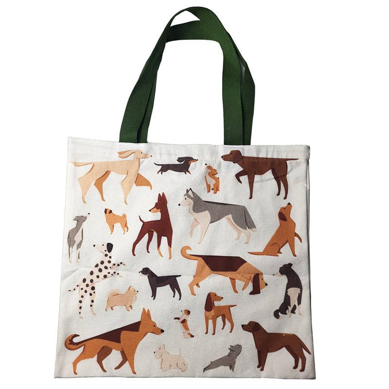Tasche aus Baumwolle in weiß mit grauem Henkel und verschiedenen Hunden als Motiv flach auf dem Boden liegend .