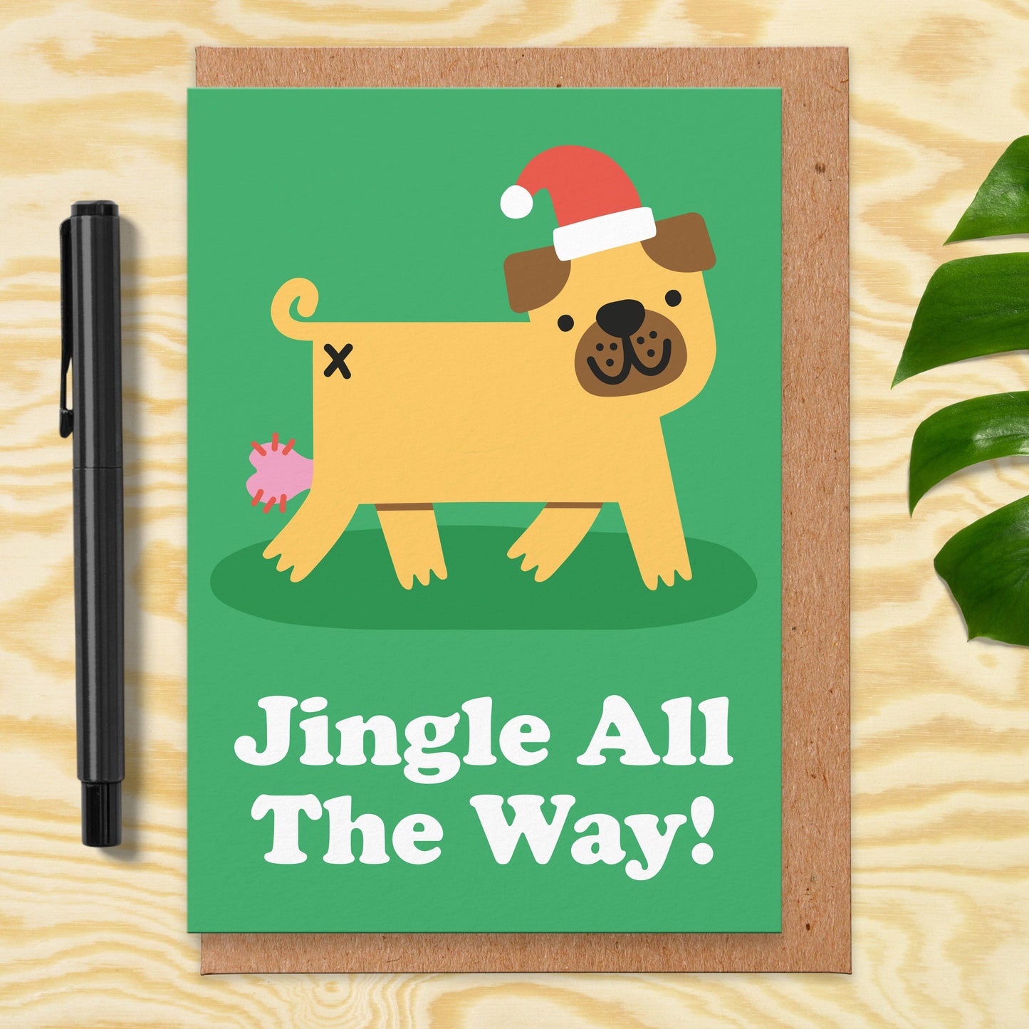 Weihnachtskarte mit Umschlag. Vorne ist ein gezeichneter Hund zu sehen mit Nikolausmütze und der Aufschrift "Jingle all the way!"